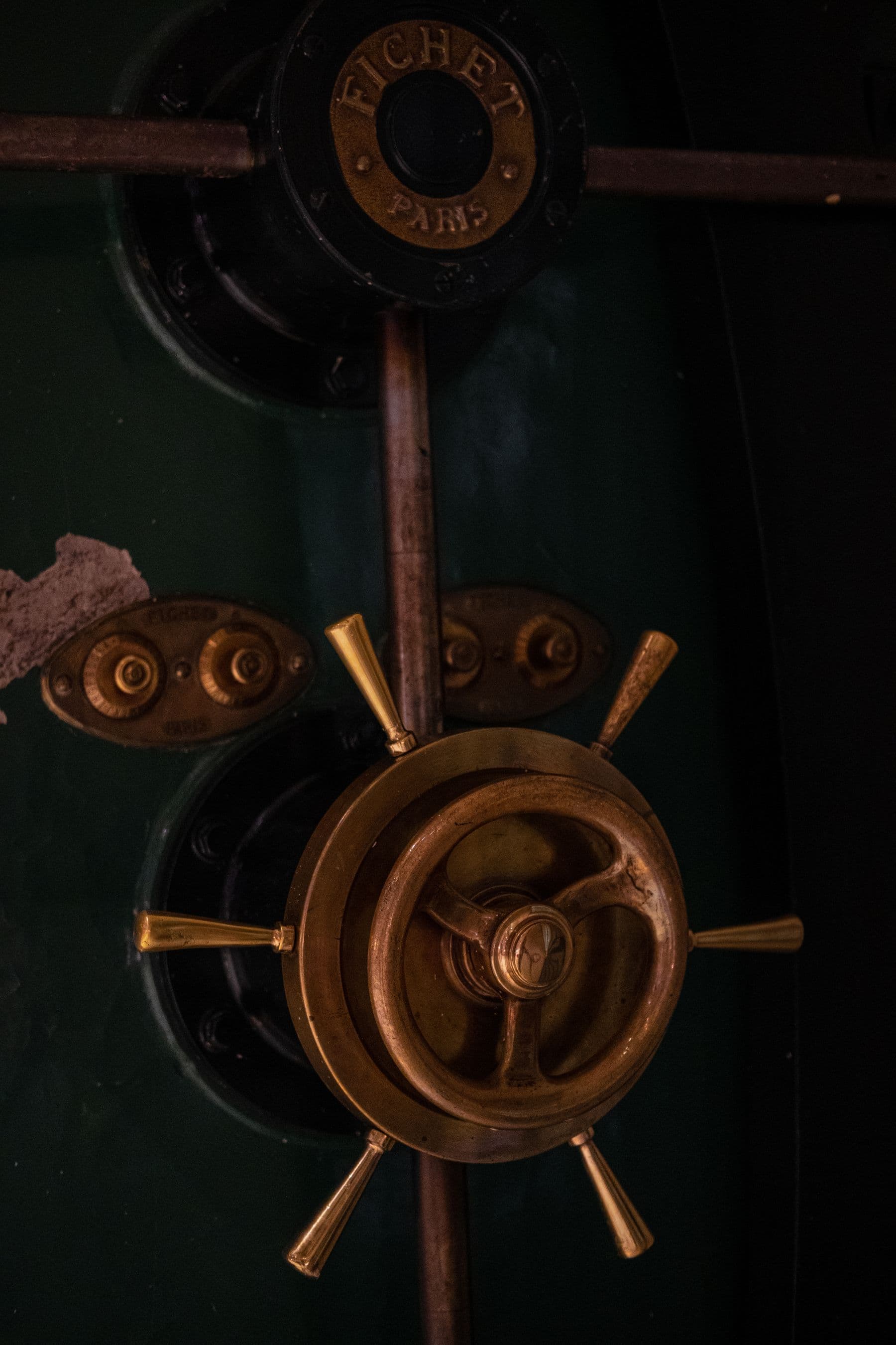 The brass wheel of a bank vault door.